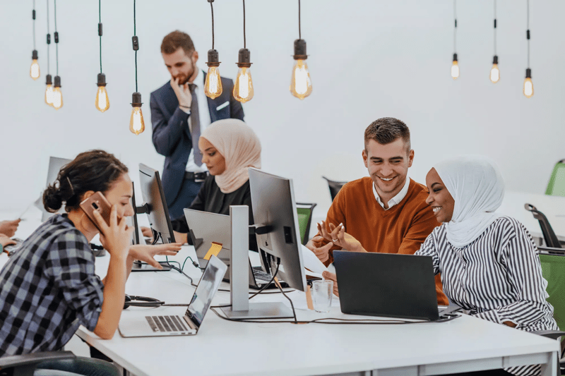 Multiethnic group of employees working in a marketing company. A group of colleagues is working on a project in modern offices
